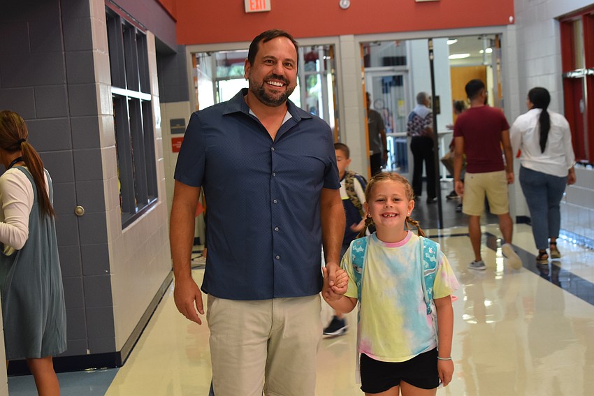 Scott Helpling walks his daughter, first grader Madison Helpling, to class. 