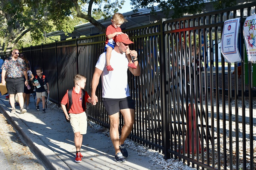 Charlie Skrzypkowski, 7, heads to second grade with his father Ryan Skrzypkowski, and brother Jack Skrzypkowski, 2.