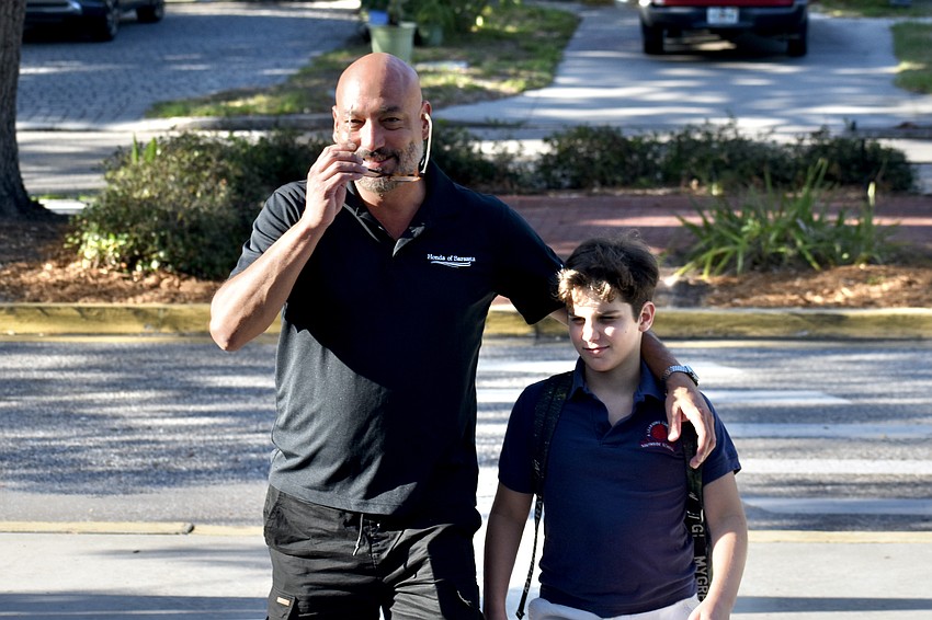 Alberto Escobar and Luca Escobar head toward school.