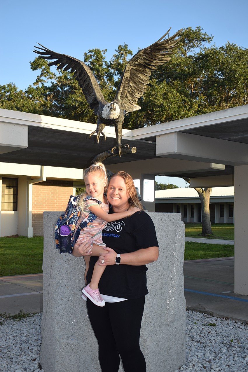 Both new to Gene Witt Elementary School, Brynlee Woods celebrates the first day of kindergarten, while her mother, Lorraine Woods, starts as a exceptional student education teacher.