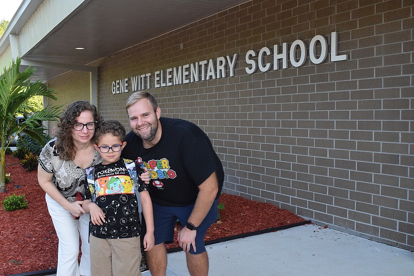 Myriam Neville, Dylan Neville, who is a first grader at Gene Witt Elementary School, and Mark Neville prepare for the first day of school. Dylan Neville is excited but a little nervous to become a bus rider.