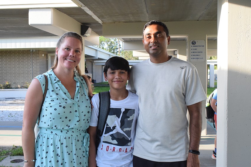 Stacy Gudiwada walks to the classroom of her son Sanjay Gudiwada, a fifth grader at Gene Witt Elementary School, with her husband, Lakshman Gudiwada. Sanjay Gudiwada looks forward to serving on the safety patrol.