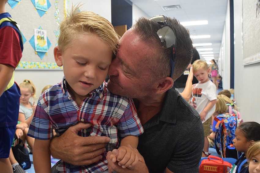 Luke Langan, a pre-K student at Gene Witt Elementary School, says another goodbye to his father, Sean Langan.