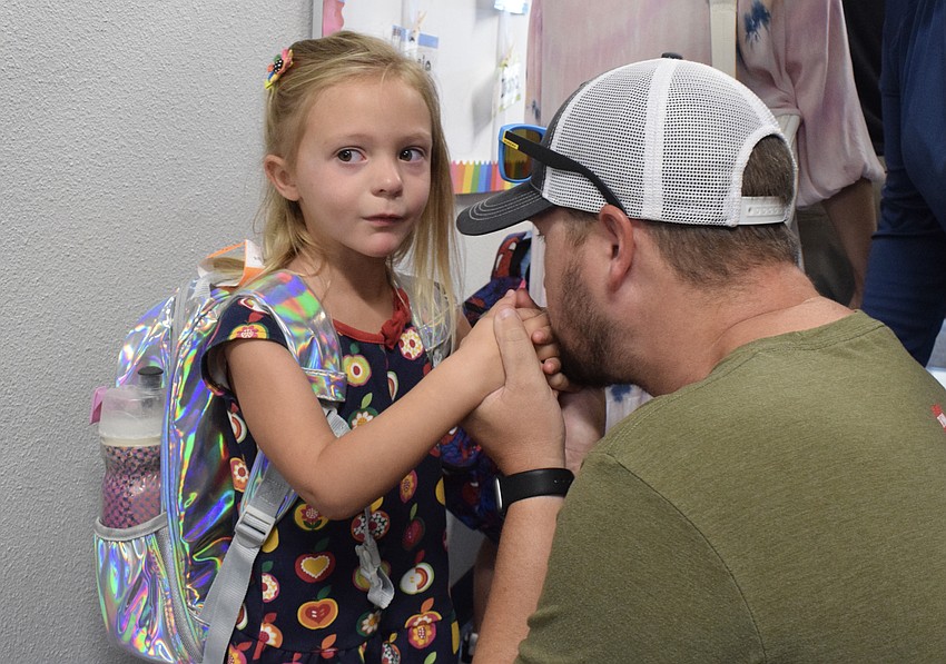 Dakota Goodyear, a pre-K student at Gene Witt Elementary School, says goodbye to her father, Brett Goodyear. She's the last child of the Goodyear family to start school.