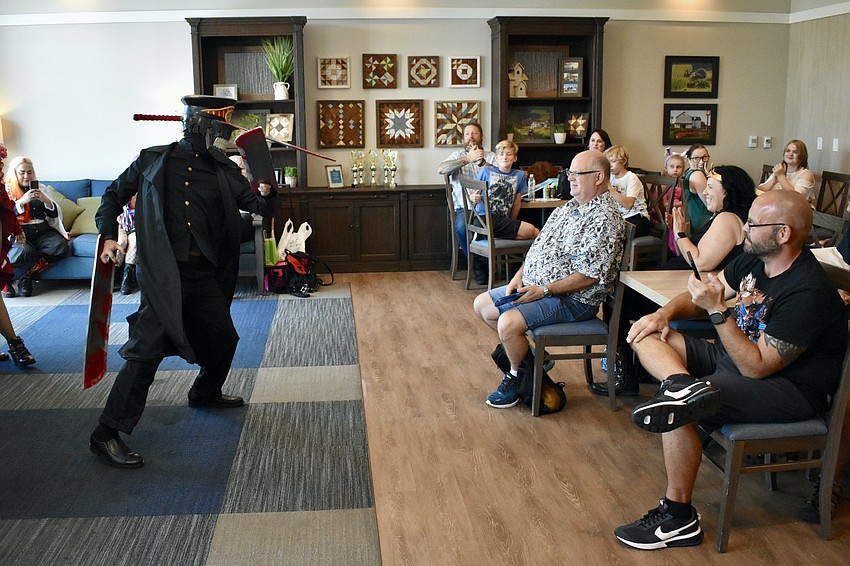 James Woo performs for the audience of the costume contest as Katana Man, a character from the anime Chainsaw Man, winning the Best Anime/Original Character award.