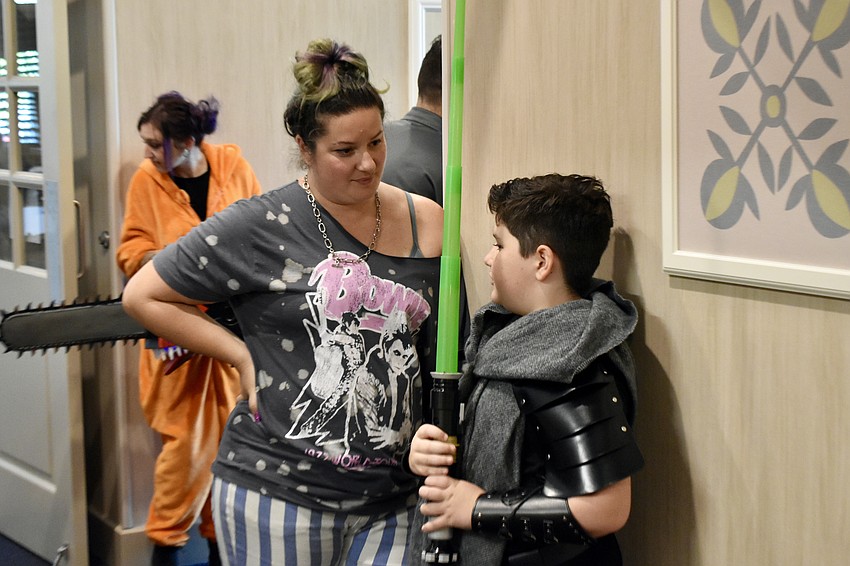 Tiffany Page talks with Jack Page, 9, who is dressed as a fanmade Star Wars character, following the costume contest.