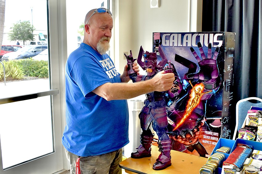 Greg Harrell adjusts a model of the Marvel Comics character Galactus.