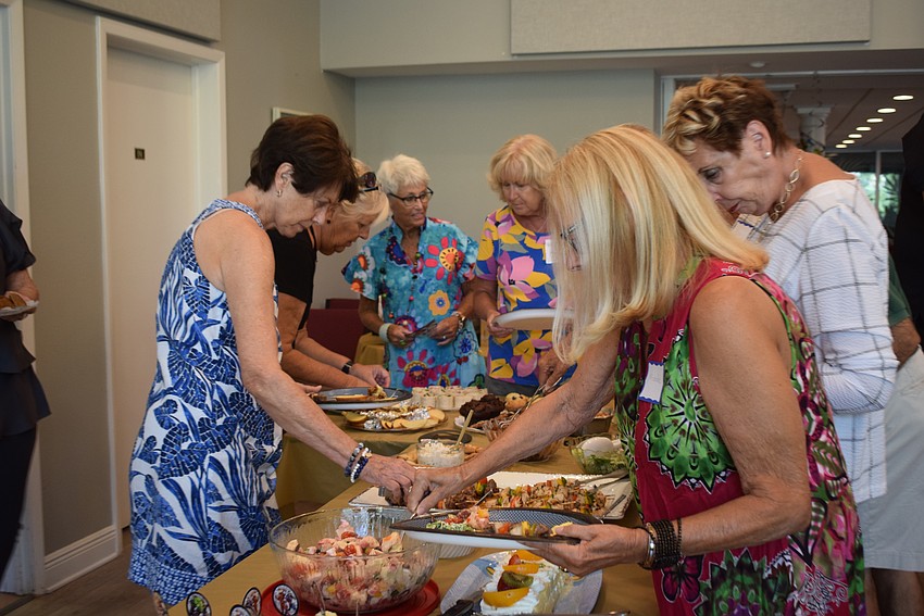 Longboat Island Chapel hosted their monthly charity happy hour collecting children's socks and shoelaces on Aug. 15.