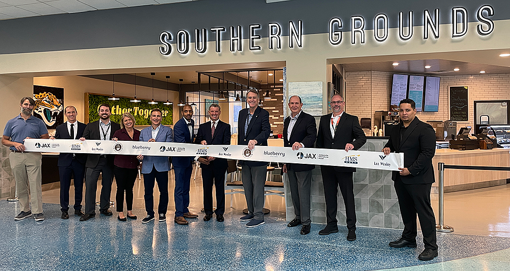 Southern Grounds owner Mark Janasik, center, at the grand opening Aug. 16 at the pre-security location at Jacksonville International Airport. The Jacksonville Airport Authority, HMSHost and Lee Wesley Group are partners in the airport concession.