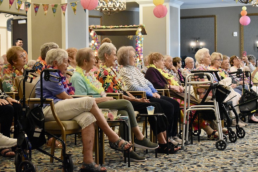 Residents at Grand Living enjoy a luau by the Royale Polynesian Revue on August 16.