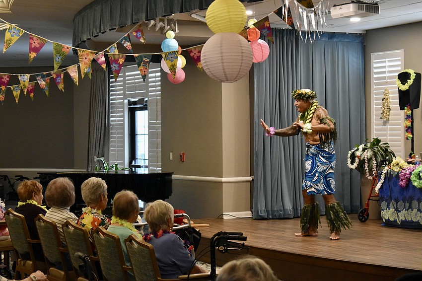 Pesi Mauga shows the audience how to hula dance.