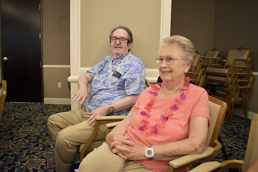 Harold Tick hula dances from his seat, as Nancy Keverian enjoys the show.