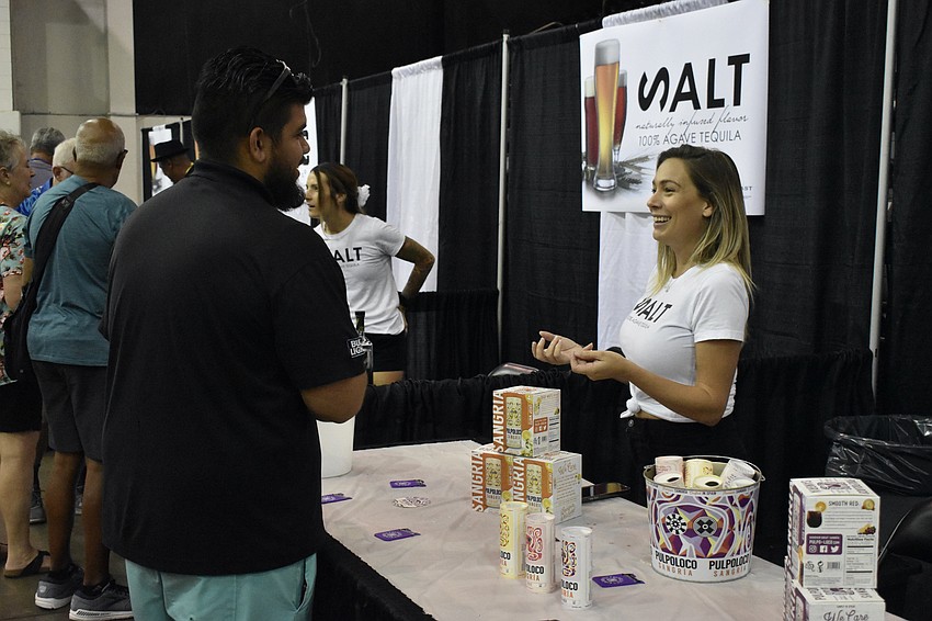 Pedro Rios talks with Rae Madure at the Pulpoloco Sangría table.