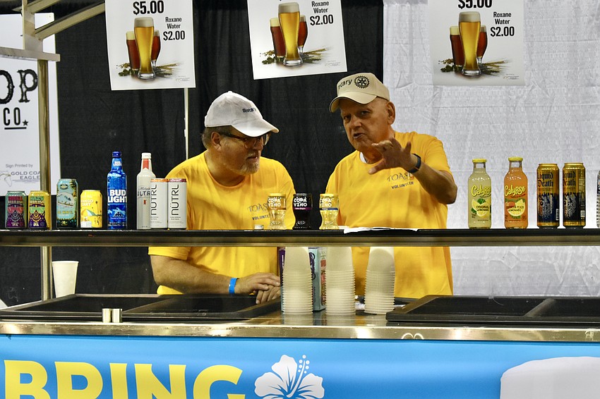 Rotary Club volunteers David Bowman and Nick Rossi staff a table at the event.