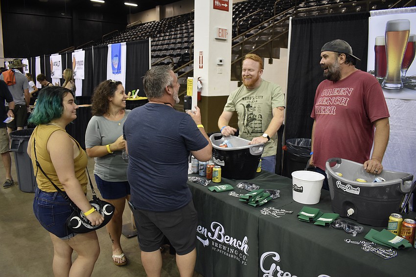 Emma, Kimberly, and Chad Evener explore the offerings at Green Bench Brewing Company with help from Cole Berra and Stephen Scmitt