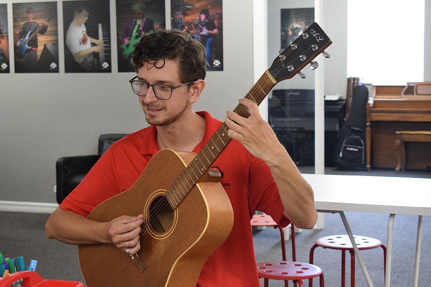 Patrick Ensslin, an instructor at Music Compound's Bradenton location, freestyles on the guitar.