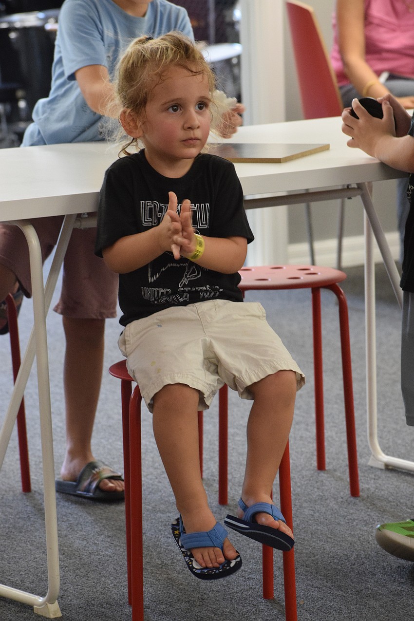 Palmetto 2-year-old Ocean Whay applauds after listening to a song at Music Compound. He has taken an interest in playing drums and guitar.