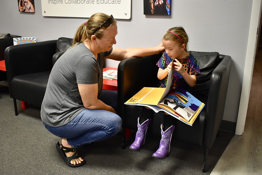 Katie McHugh watches as her daughter, 5-year-old Harper Barleycorn, reads 