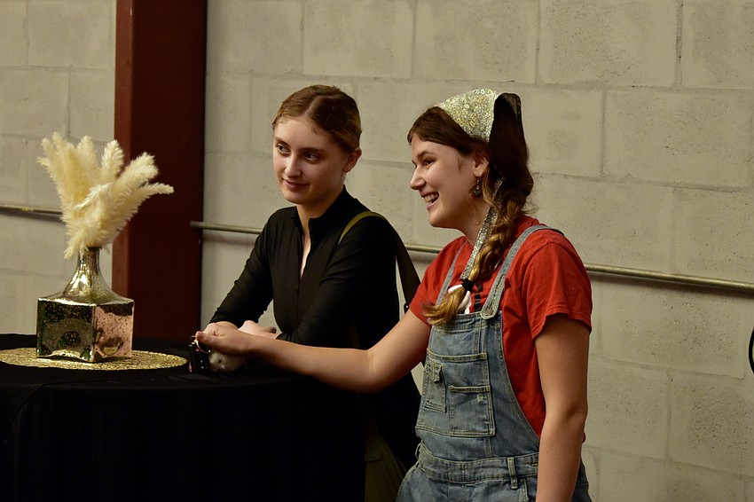 17-year-old Aurora Newcomb and 18-year-old Chloe Johnson watch a performance.