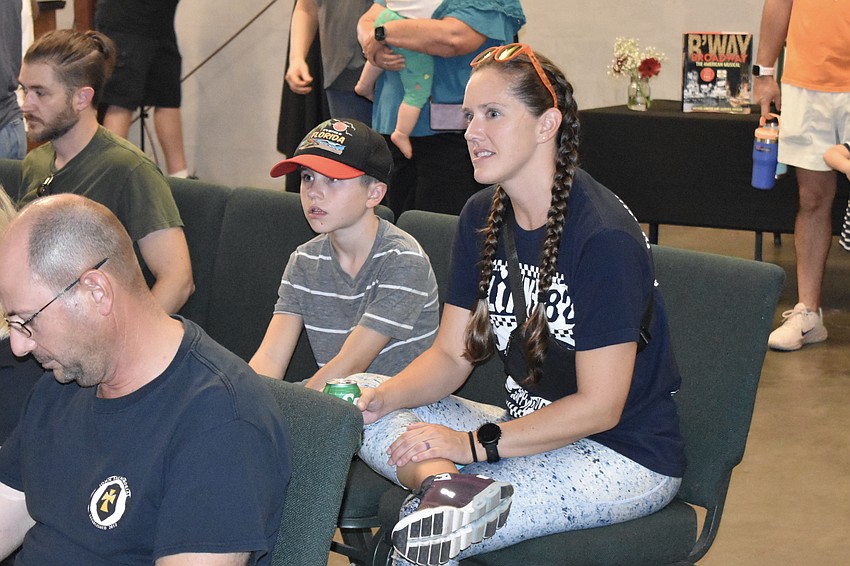 Eleven-year-old Music Compound student Dexter Trombetta and Brady Jo Trombetta watch a student performance.