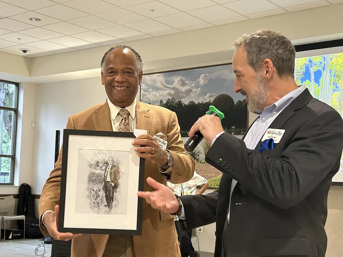 Tiger Bay Club co-founder Greg David received a pencil sketch of himself and a tiger drawn by artist Robyn Cowlan, commissioned by Cheri Orr, to commemorate his time as the club's president. Photo courtesy of the Tiger Bay Club