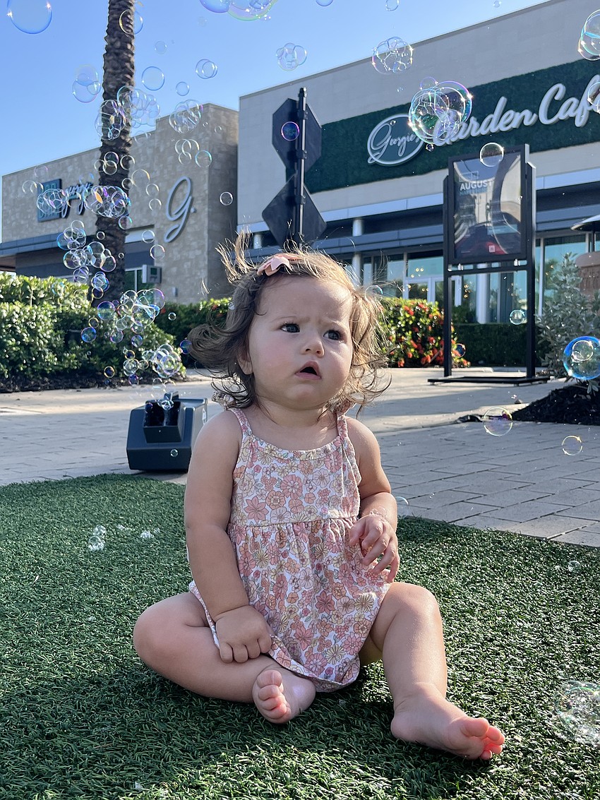 Lakewood Ranch 7-month-old Evelyn Stillman watches the bubbles as they float around her.