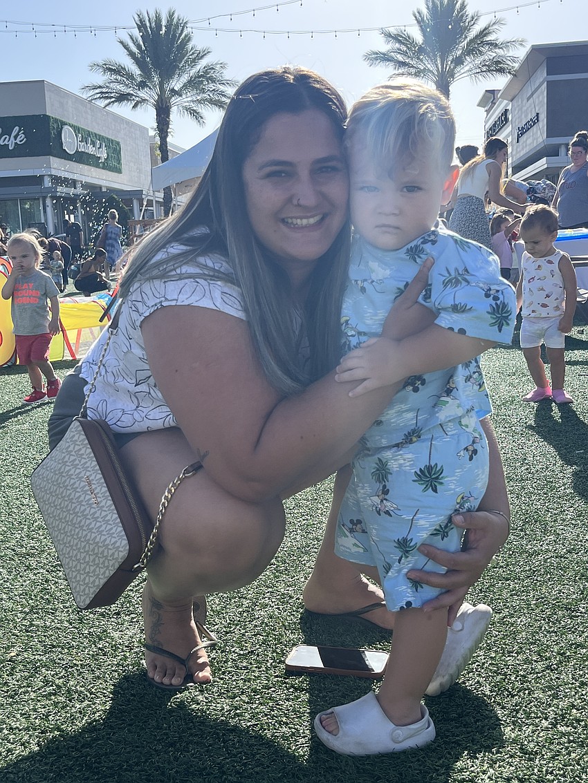 Lakewood Ranch's Pollyanna Soares and her 2-year-old son Benjamin Soares check out the various activities available at UTC Kids Club.
