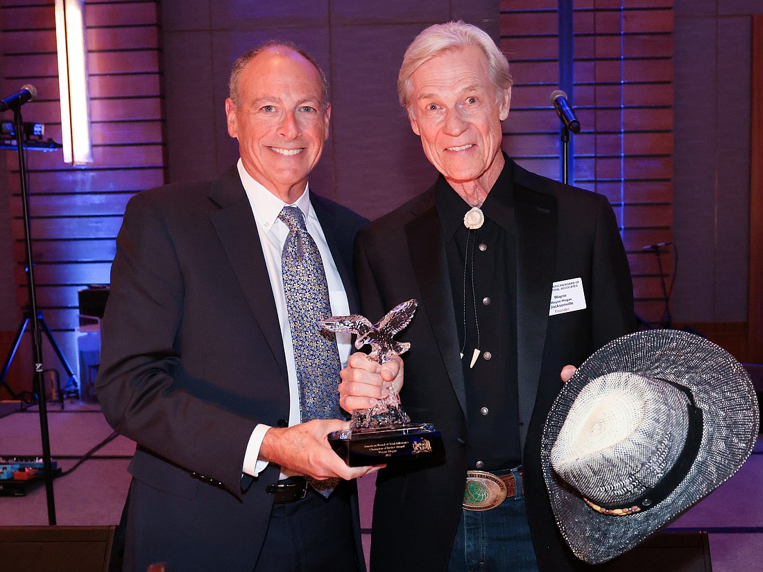 Jacksonville attorney Wayne Hogan, right, accepted the American Board of Trial Advocates Champion of Justice Award from ABOTA National Board member Joshua Whitman on Aug. 19 at the organization’s meeting in Canada.