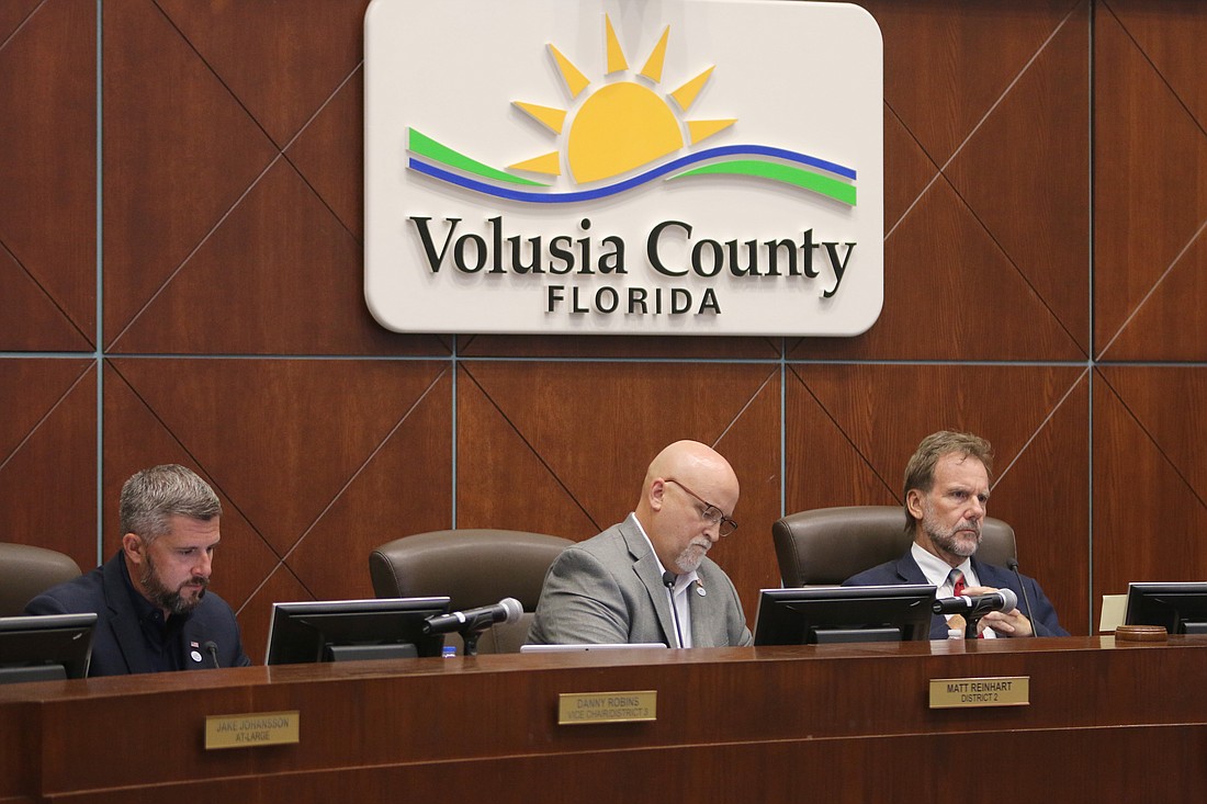 Volusia County Councilmen Danny Robins, Matt Reinhart and Chair Jeff Brower listen to county staff speak during the special meeting regarding the proposed Belvedere Terminals fuel depot in Ormond on Wednesday, Aug. 23. Photo by Jarleene Almenas