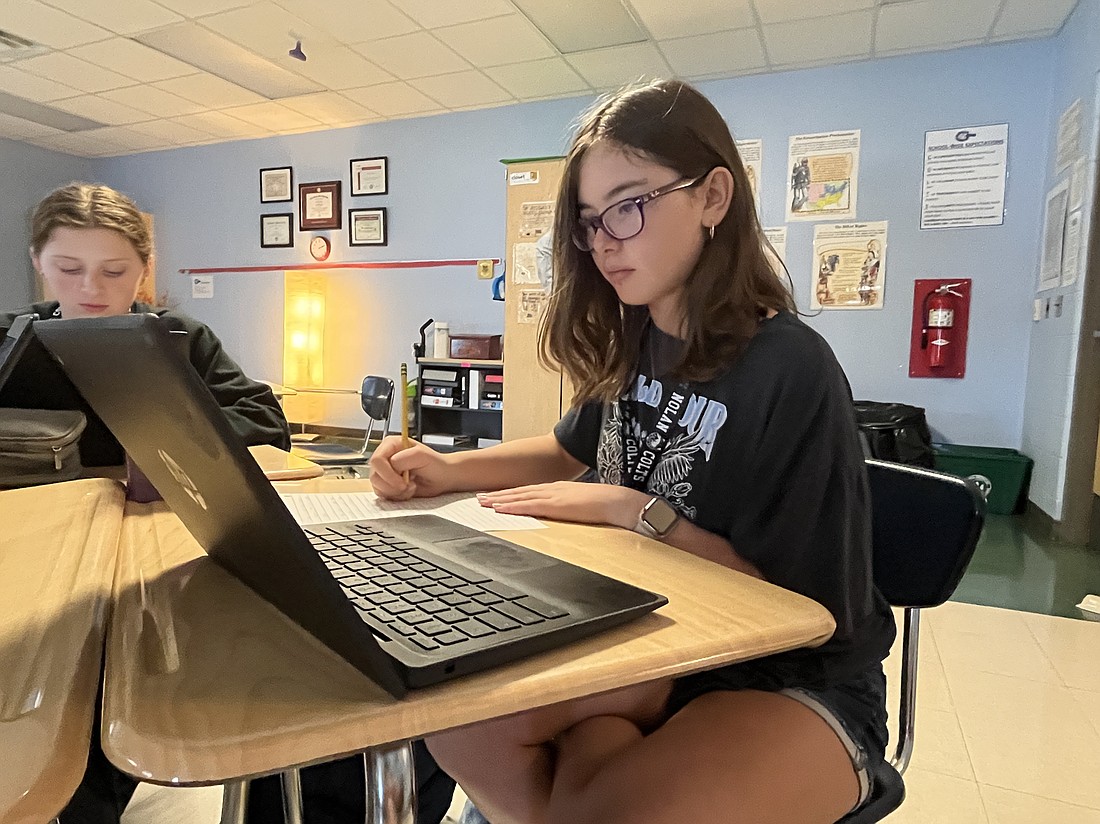 Kylee Davis, an eighth grader at R. Dan Nolan Middle School, diligently works on a pre-AP World History and Geography assignment.