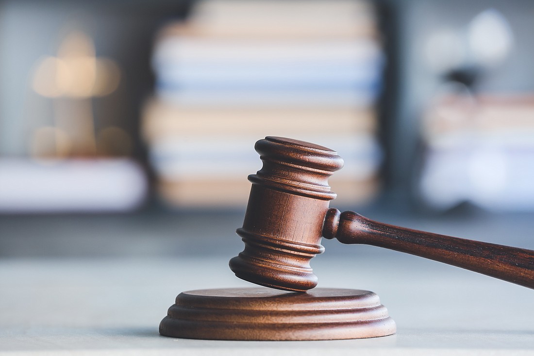 A judge's gavel on a table. Photo from Adobe Stock