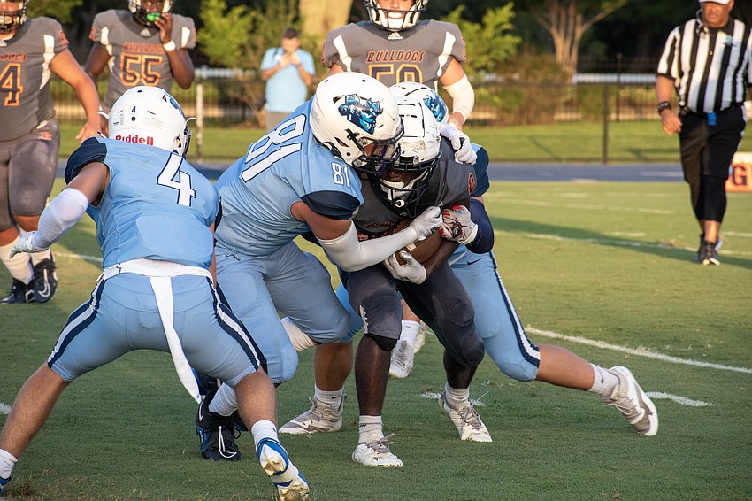 ODA junior Thomas Perez (81) and senior Chase Taraska combine for a tackle on Berean Christian's La'Morris Barrett.