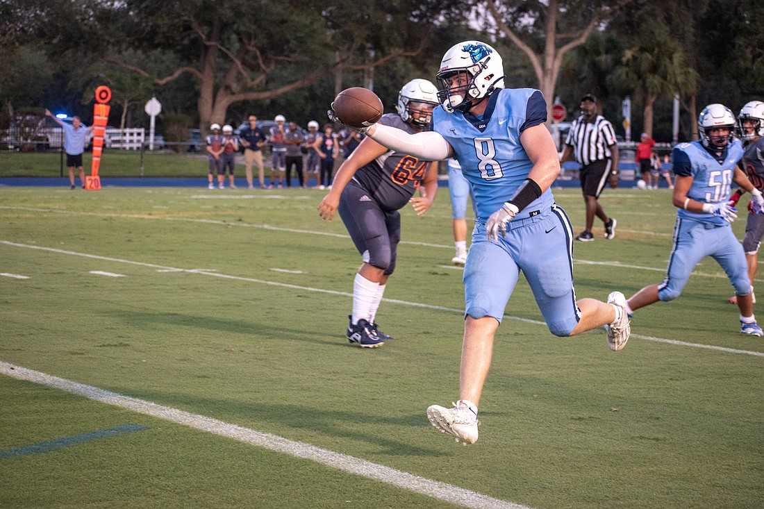 ODA senior linebacker Charlie Tack stretches the ball over the goal line for a pick six against Berean Christian.