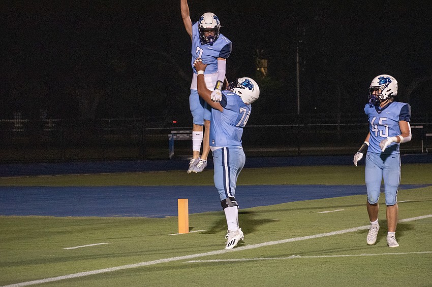 ODA sophomore Dylan Walker (2) is lifted by junior Marvin Palominos after Walker scored a rushing touchdown against Berean Christian. ODA does not have a rushing touchdown since week one.