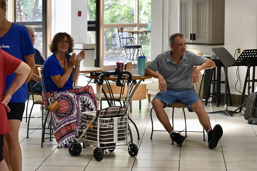 Lynda Donlon clams to the performance, watching with her husband Brian Donlon.