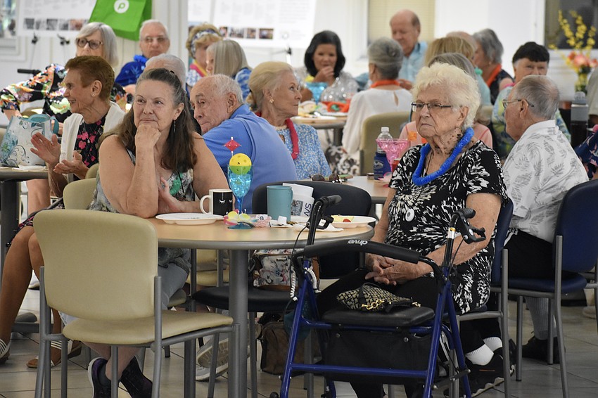 Lori Ryan and Jean Rouke watch the couples in the room dance.