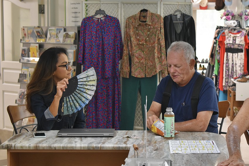 Senior Friendship Centers assistant manager Evelyn Vaz talks with Wayne Skidmore.