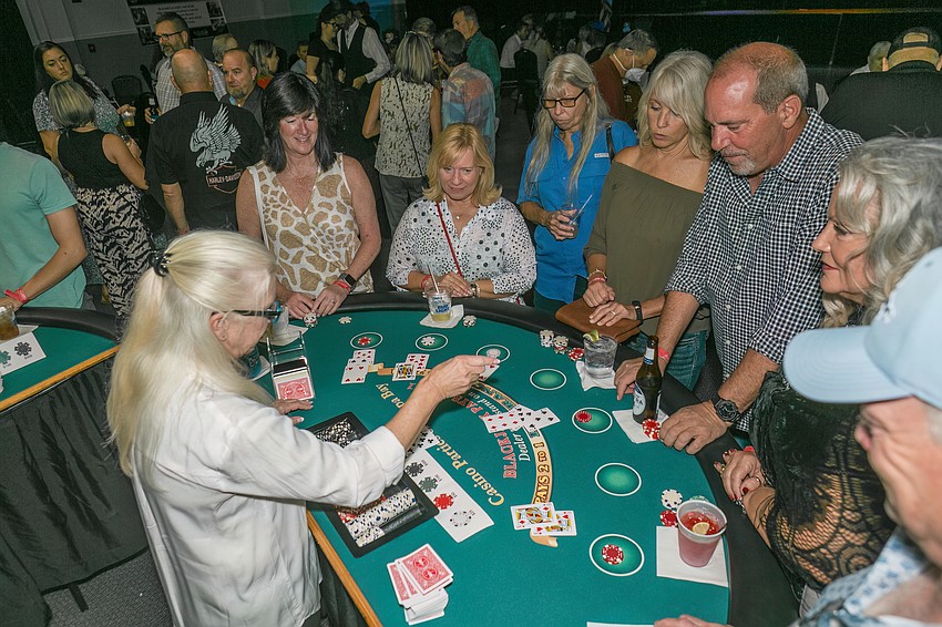 Blackjack players crowd the tables at the Suncoast Charities for Children's Casino Night.