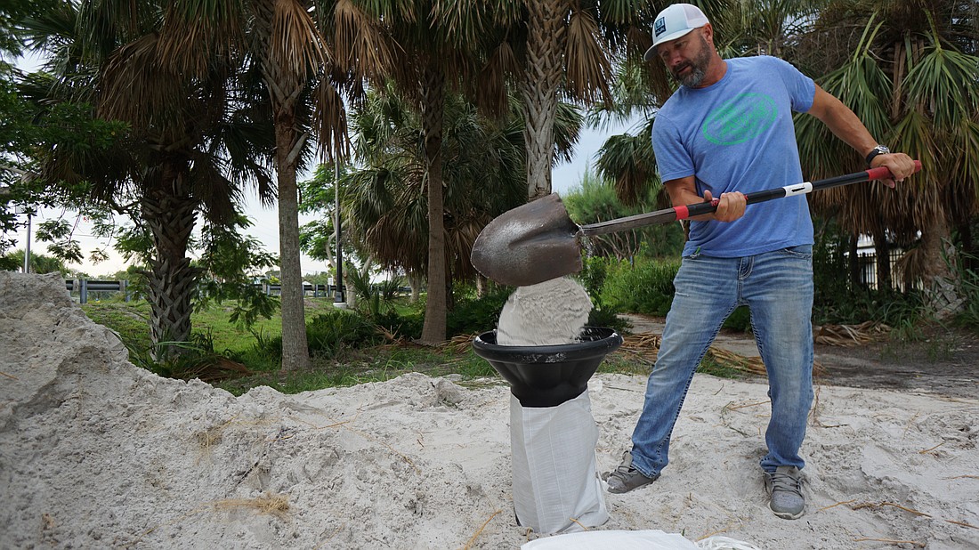Longboat Key resident Roger Lusins was one of many residents that took advantage of the 10 free sandbags offered by the town on Tuesday.