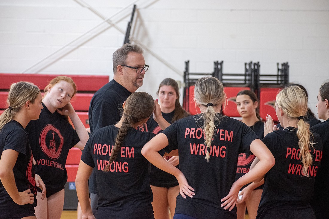 Chad Davis talks with his Cardinal Mooney High volleyball team following an Aug. 28 practice. Davis said he expects the Cougars to be as strong as ever in 2023.