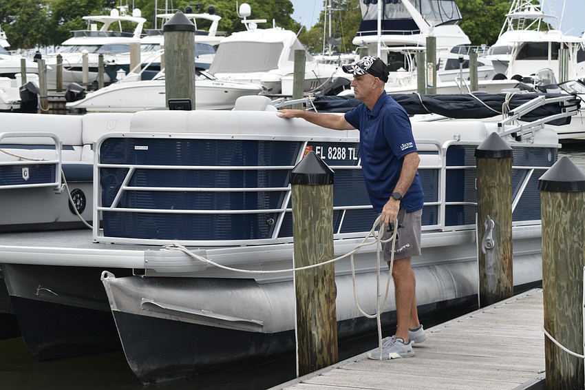 Joel Yoder of Freedom Boat Club secures a boat at Bayfront Park on Tuesday