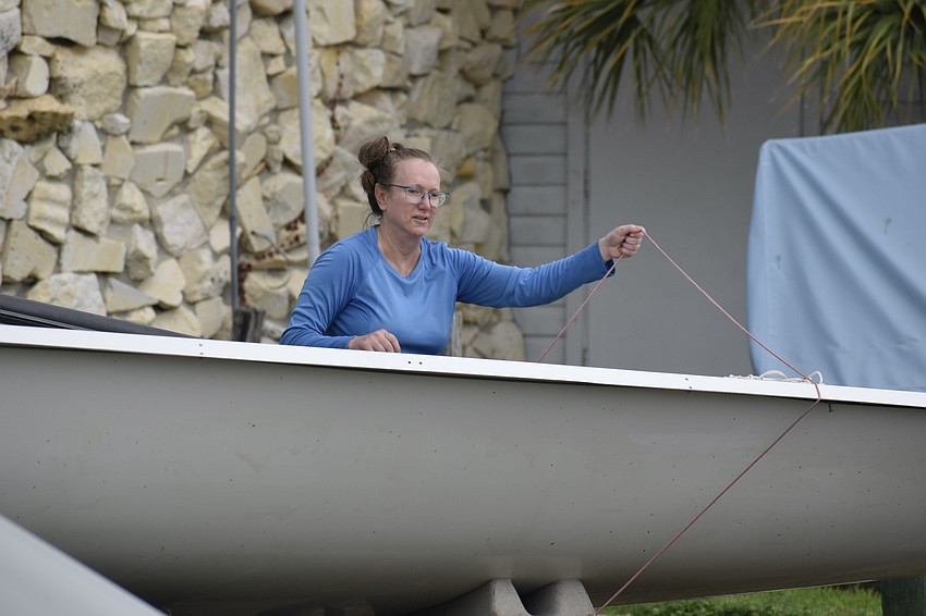 Michelle Lee secures her boat at the Sarasota Sailing Squadron.