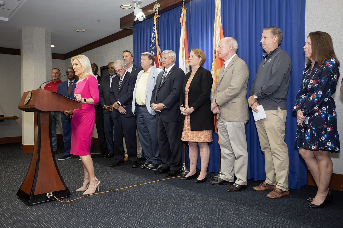 Mayor Donna Deegan, backed by the CEOs of the city’s independent authorities, former general counsels, attorneys, elected officials and business leaders, speaks Aug. 23 at a news conference in support Randy DeFoor, fourth from right, her nominee for city attorney.