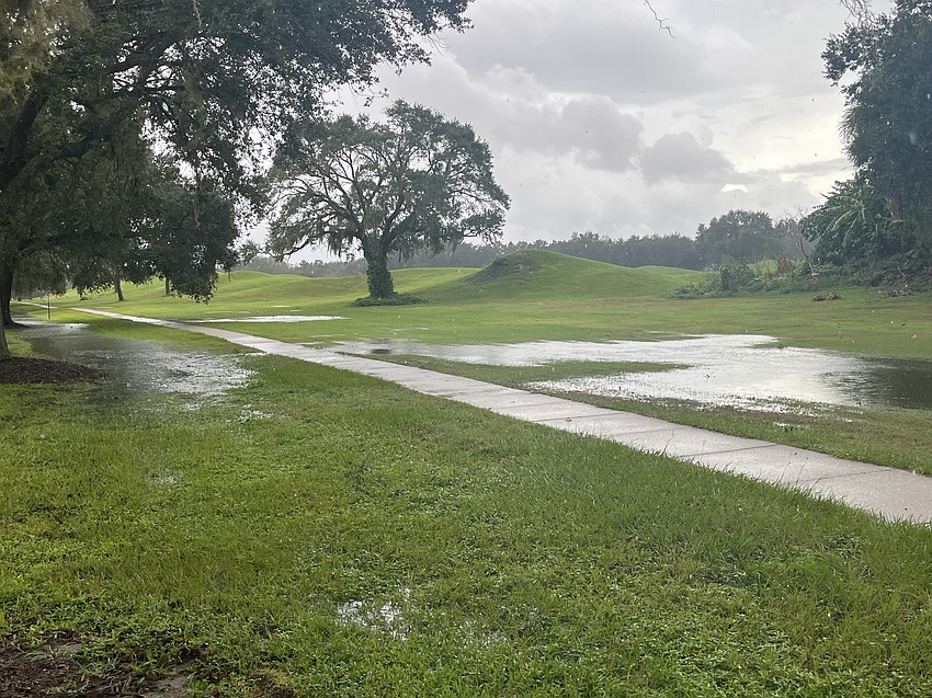 Water continues to flood an area near River Club Golf Course. The area typically floods during heavy rainfall.
