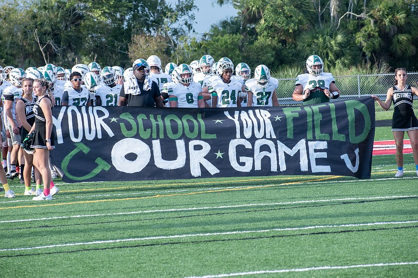 The Lakewood Ranch Mustangs prepare to take the field against Cardinal Mooney.