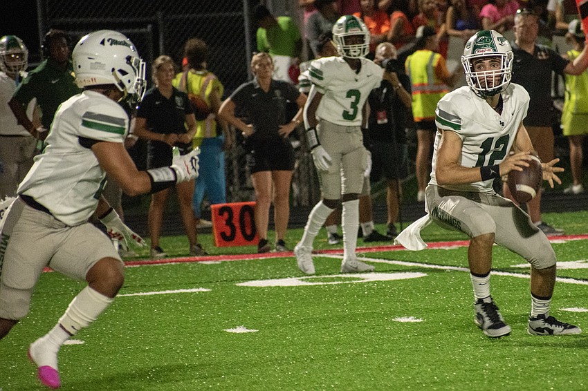 Lakewood Ranch senior quarterback Sebastian Mejia (12) pitches to senior running back Teagan Randall.