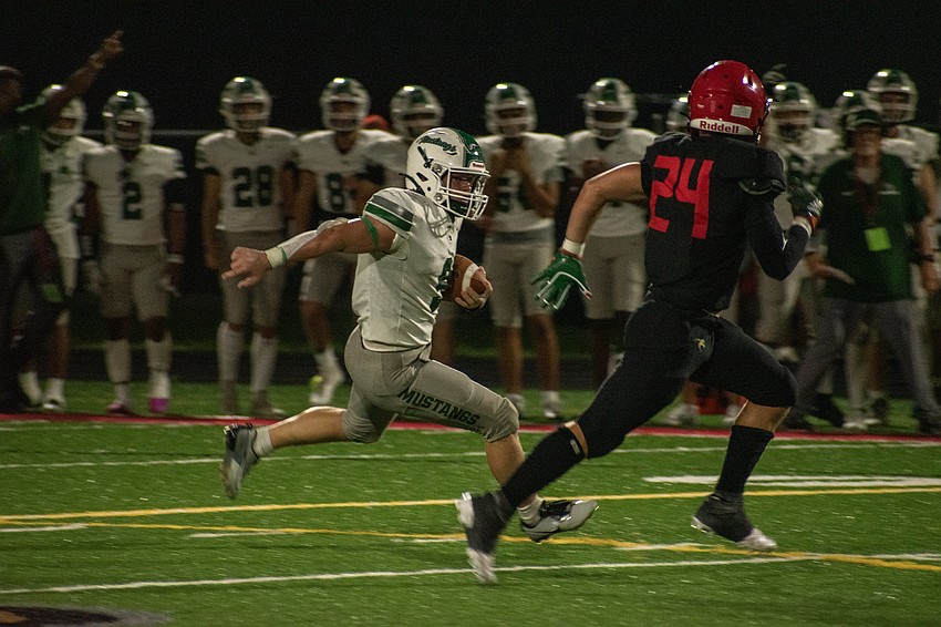 Lakewood Ranch senior running back Simon Freed cuts back to avoid Mooney senior Emerson Warthling.