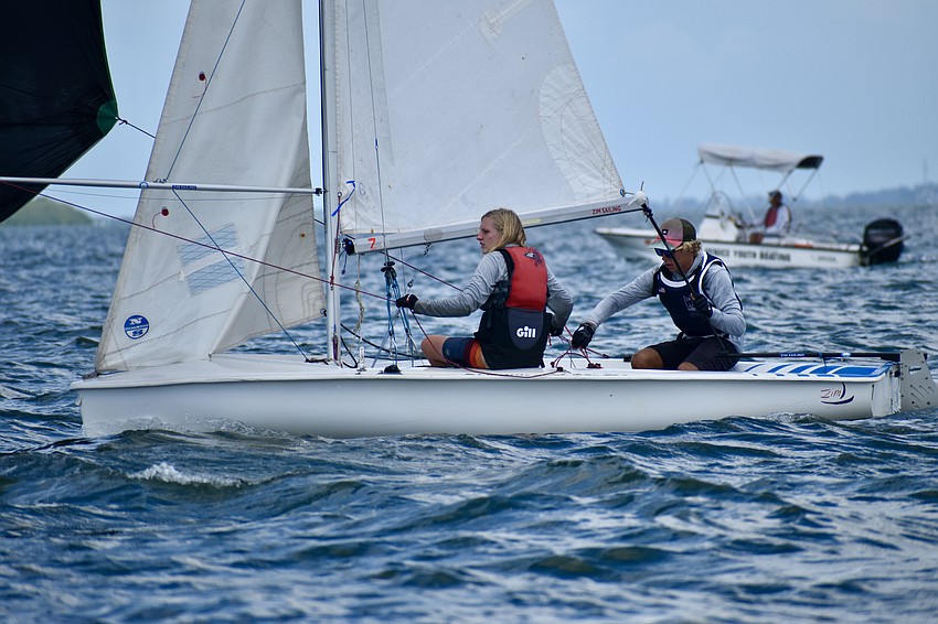 Cole Wall and Kyan Clark of Sarasota Youth Sailing unfurl the sail on their Club 420.