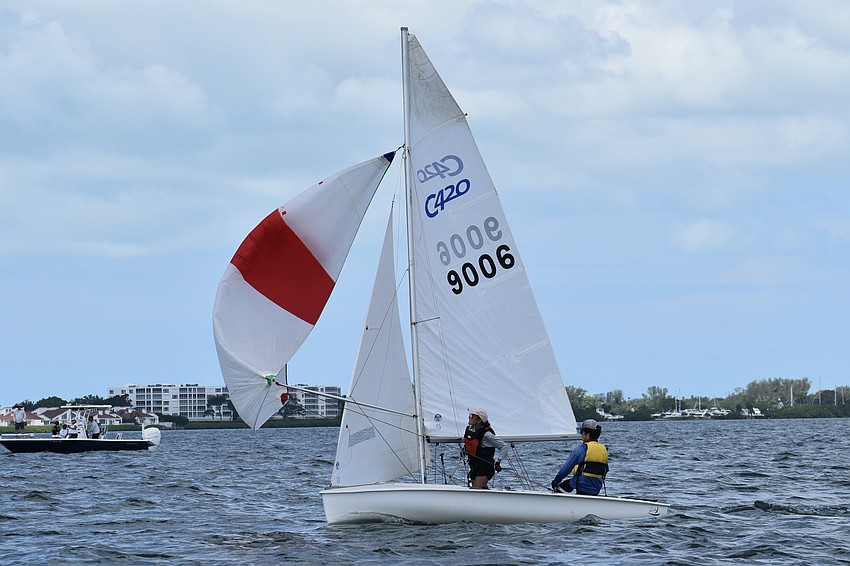 Katie Boyle and James McCauley of Venice Youth Boating Association unfurl the spinnaker on their Club 420.