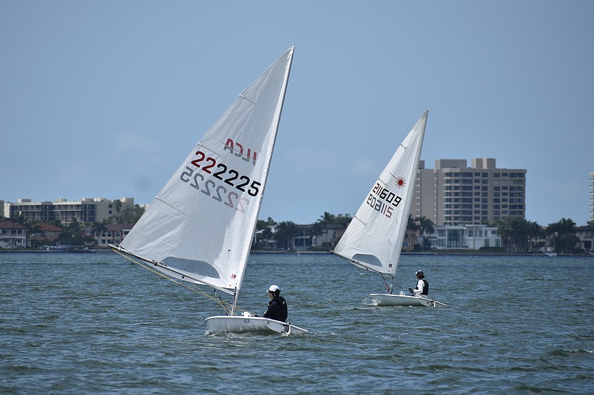 Anda Taksinapan of Sarasota Youth Sailing and Rory Maher of St. Petersburg Yacht Club race in Lasers.